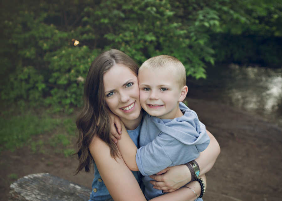 Mother smiles as she hugs son with ADHD