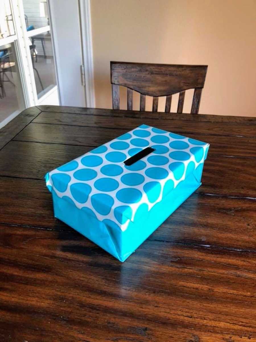 Box wrapped in wrapping paper on table teacher set out for students to write notes to her that they don't want to say out loud