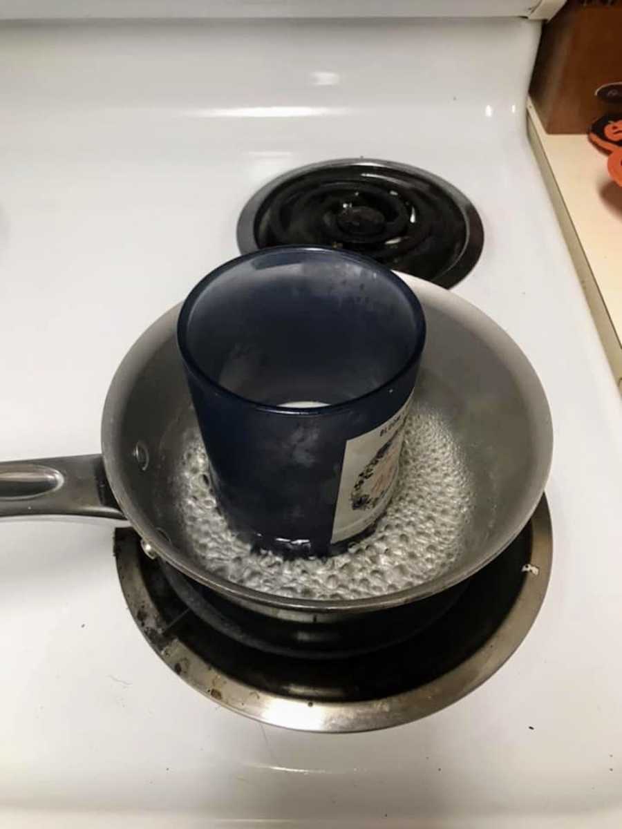 Candle sitting in pot of boiling water on stove