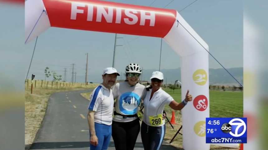 Woman who had heart transplant at finish line of race with man and woman beside her