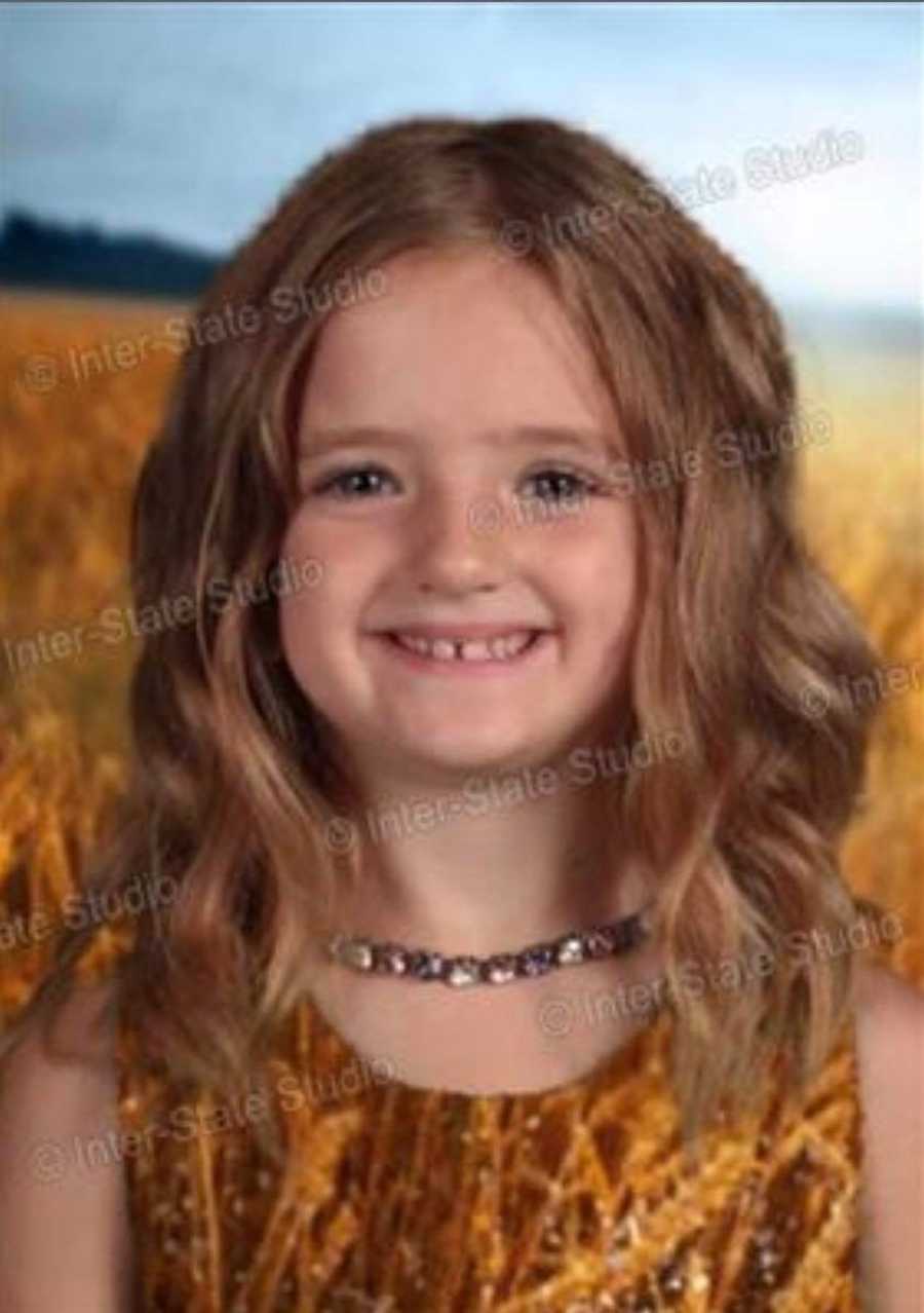 Little girl's head floating in field from wearing green dress that blends in with green screen