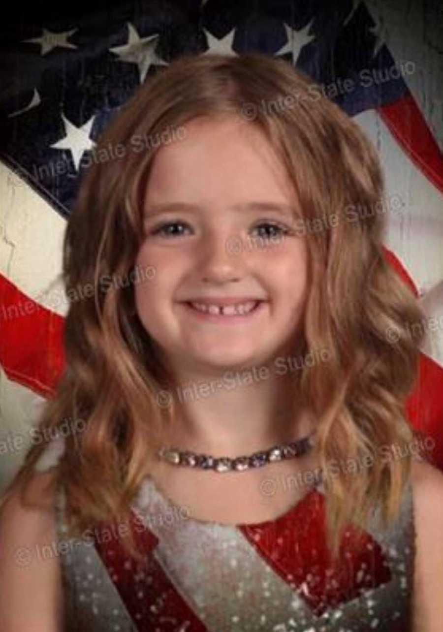 Little girl's head floating in front of American Flag from wearing green dress that blends in with green screen