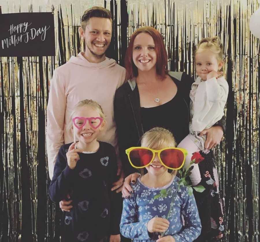 Mother who got clean stands smiling beside husband and three daughters on Mother's Day