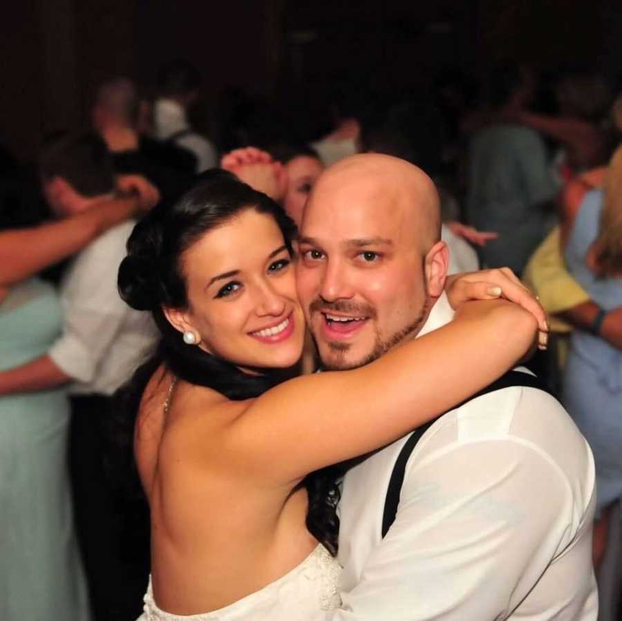 Bride who got clean smiling with arms around groom