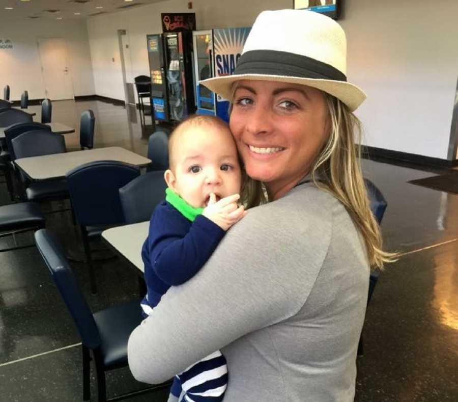 Mother stands smiling holding son with Febrile Seizures