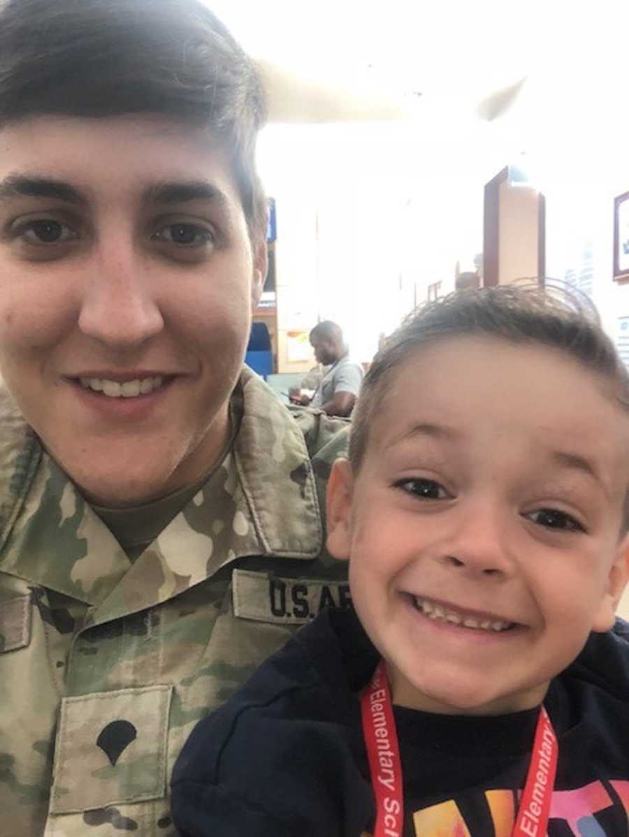 Army mother in uniform sits smiling with foster son in selfie