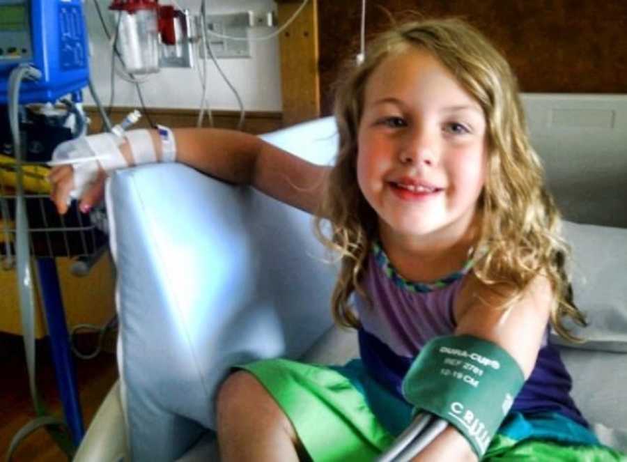 Little girl with absence and petit mal seizures smiles in hospital with bandages on her hand
