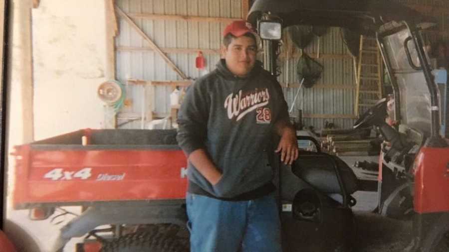 Teen who died in car accident standing in front of a red four wheeler