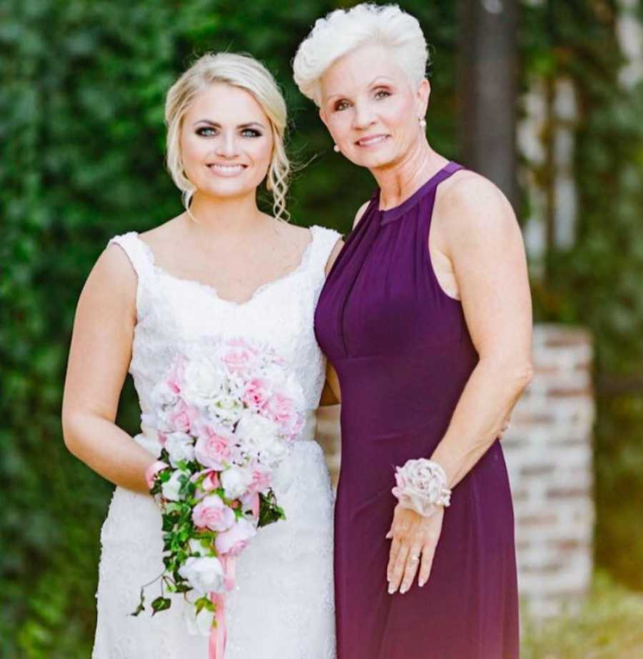 Bride stands smiling with mother who has since passed away