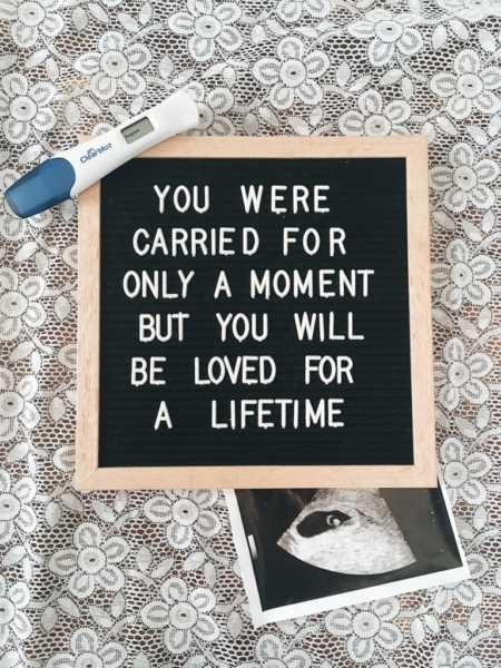 Pregnancy test and picture of ultrasound beside sign that says, "You were carried for only a moment but you will be loved for a lifetime"