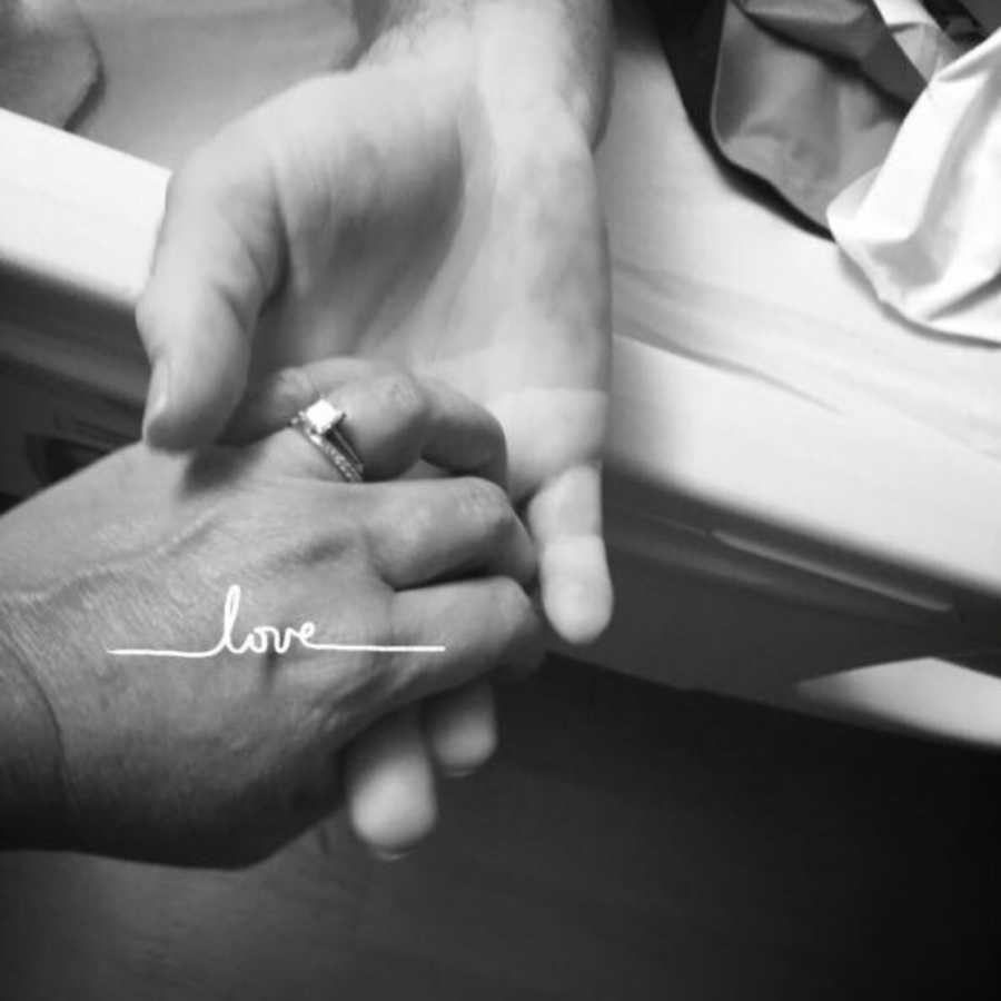 Close up of wife holding husband's hand in hospital before he passes from pancreatic cancer