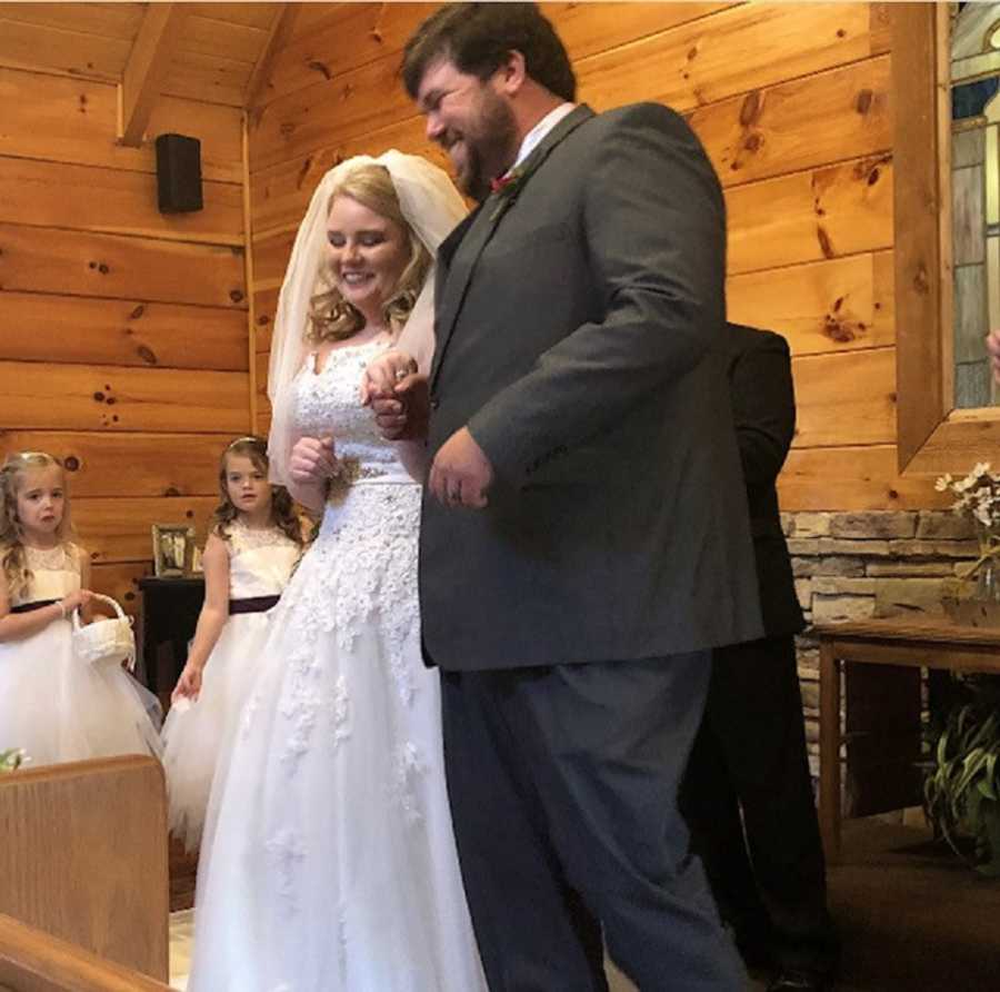 Bride with endometriosis holds groom's hand