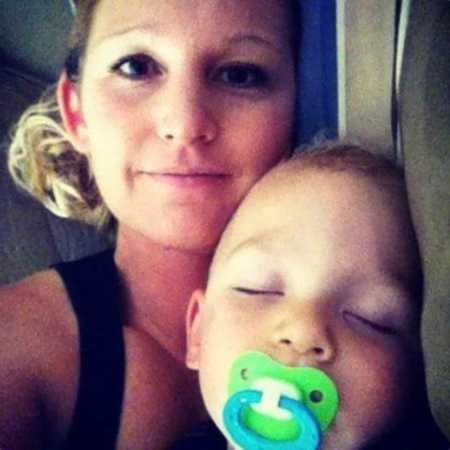 Mother with bipolar disorder smiles in selfie beside her son who is sleeping with pacifier