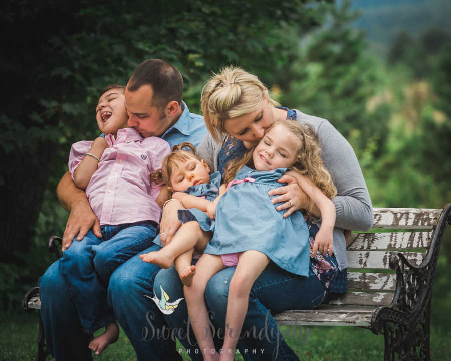 Foster parents sit on bench with two foster kids with shaken child syndrome and third with bilateral open lip schizencephaly