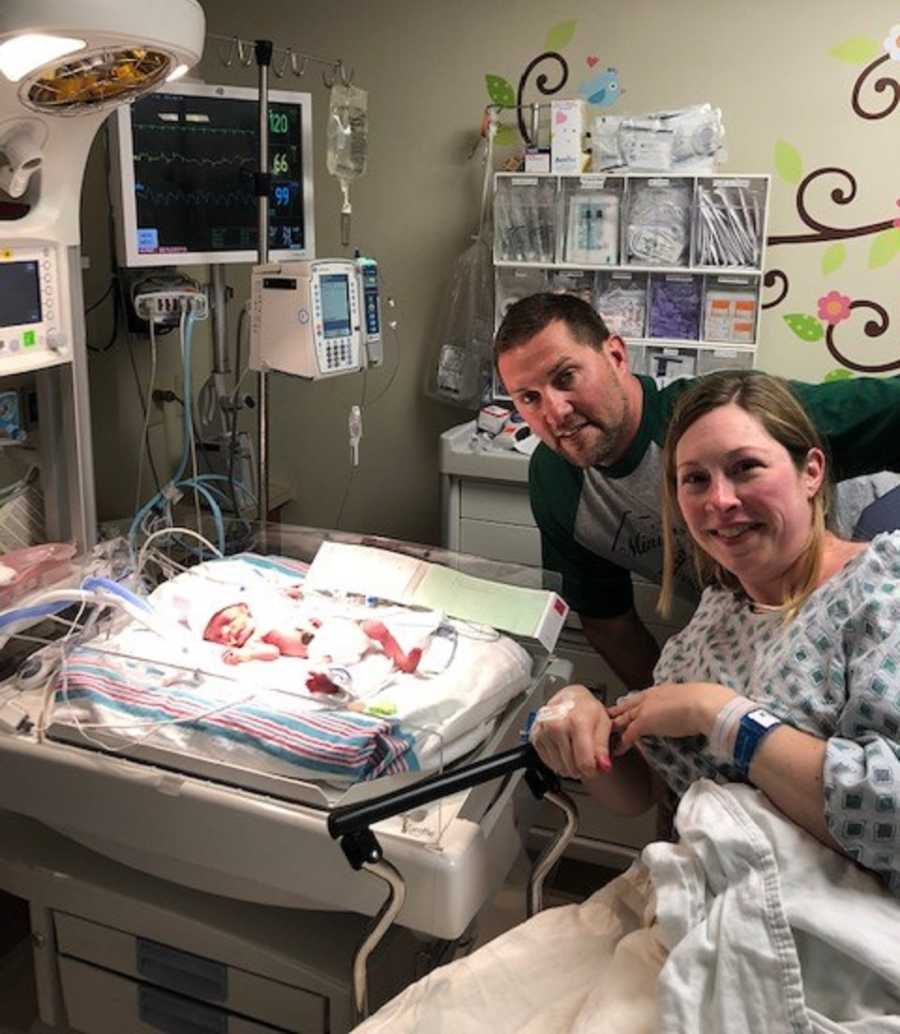 Mother with HELLP smiles with husband as they watch over newborn in NICU