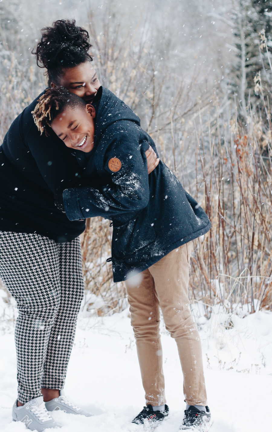 Birth mother hugging son she gave up for adoption outside in snow