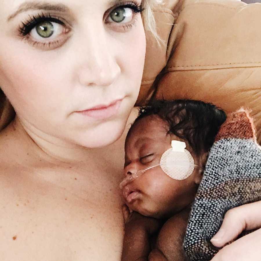 Woman takes selfie while preemie adopted daughter lays asleep on her bare chest