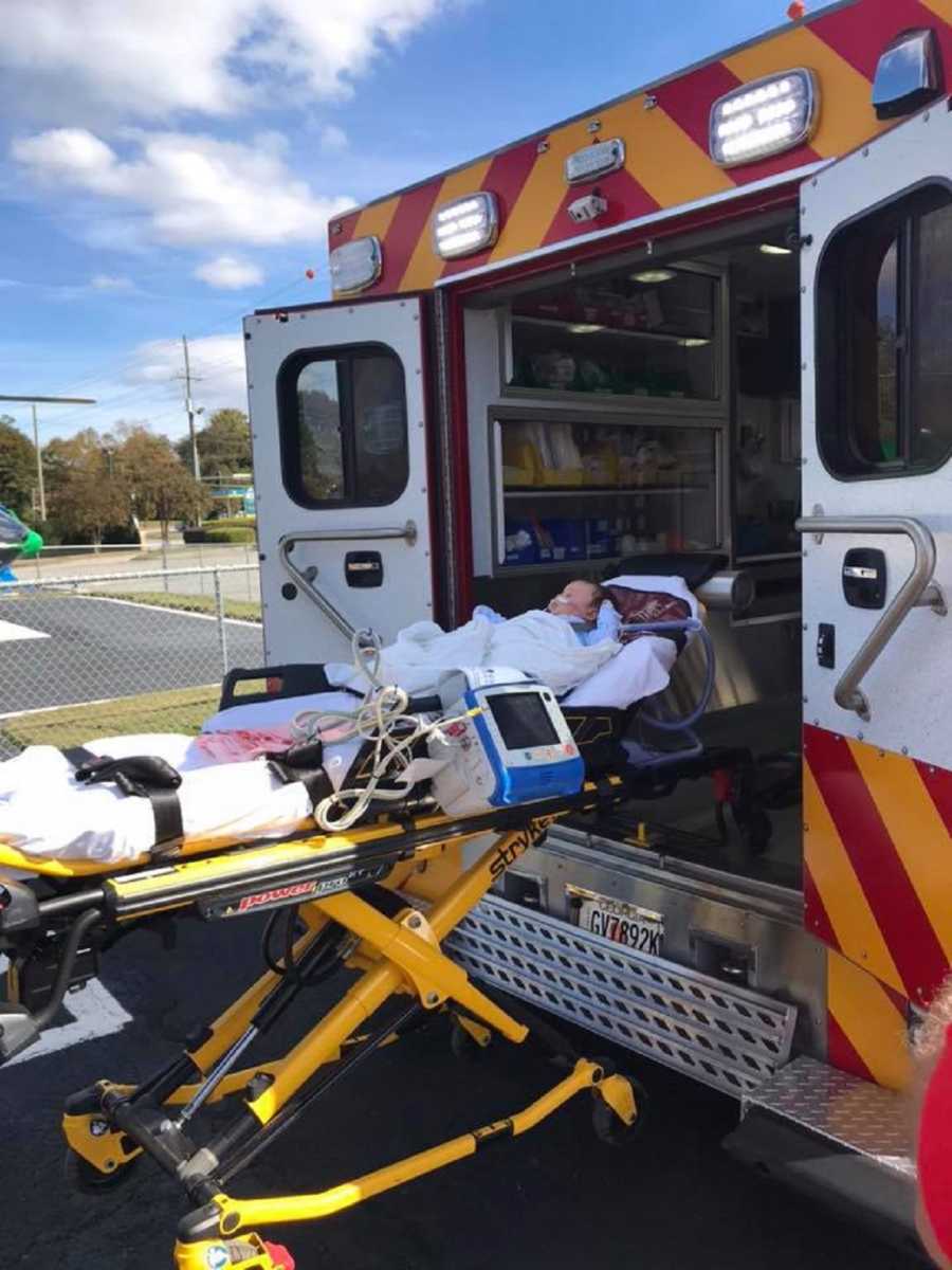 Baby on stretcher being loaded into ambulance