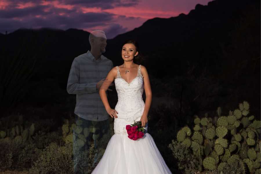 Woman in wedding dress stands with ghost of her late fiancee standing beside her in photoshoot