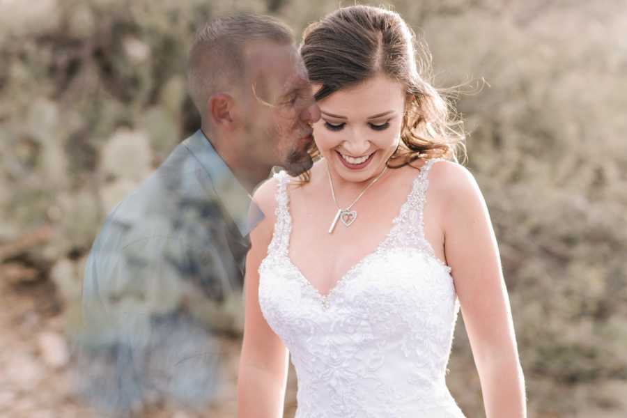 Woman stands smiling in wedding dress with ghost of her late fiancee beside her in photo shoot