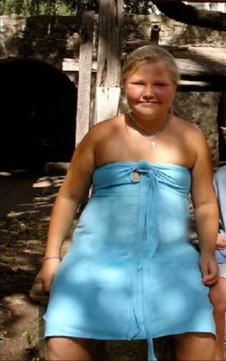 Teen who was bullied for her weight sits outside in blue strapless dress