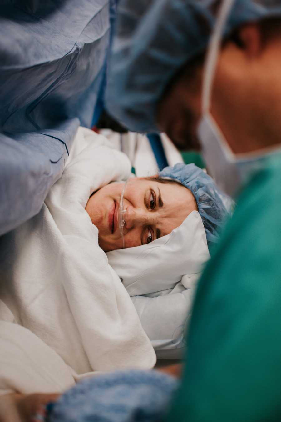 Pregnant woman who had c section looks over at newborn in heart failure crying