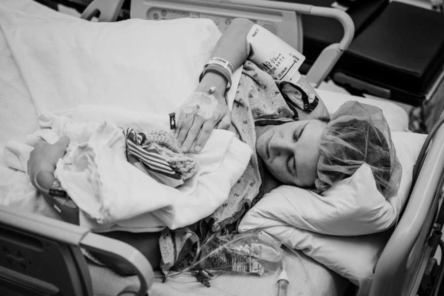 Woman who just gave birth to son with heart failure holds him in her arm as he is wrapped in blankets