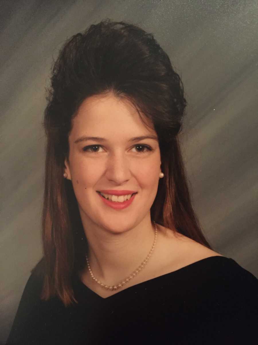 Teen in 90's smiles for school picture