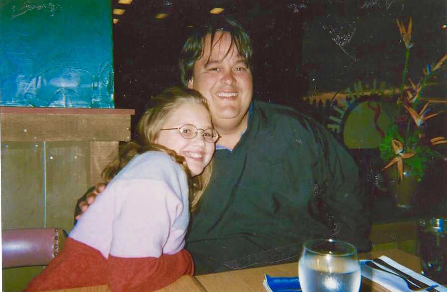 Father who has since passed smiles beside daughter as they sit at restaurant table