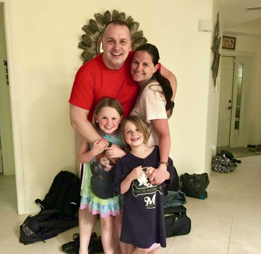 Wife smiles in home with two daughters and husband who went into cardiac arrest