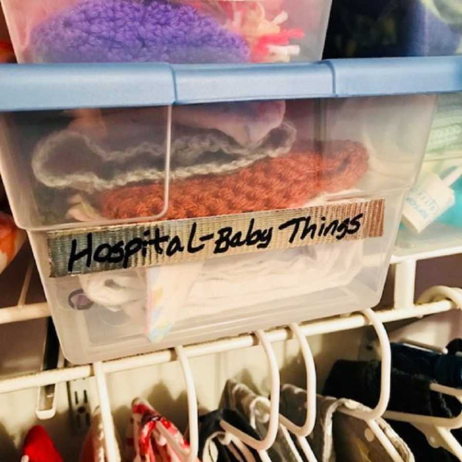 Plastic bin in closet labeled "Hospital-BAby Things"