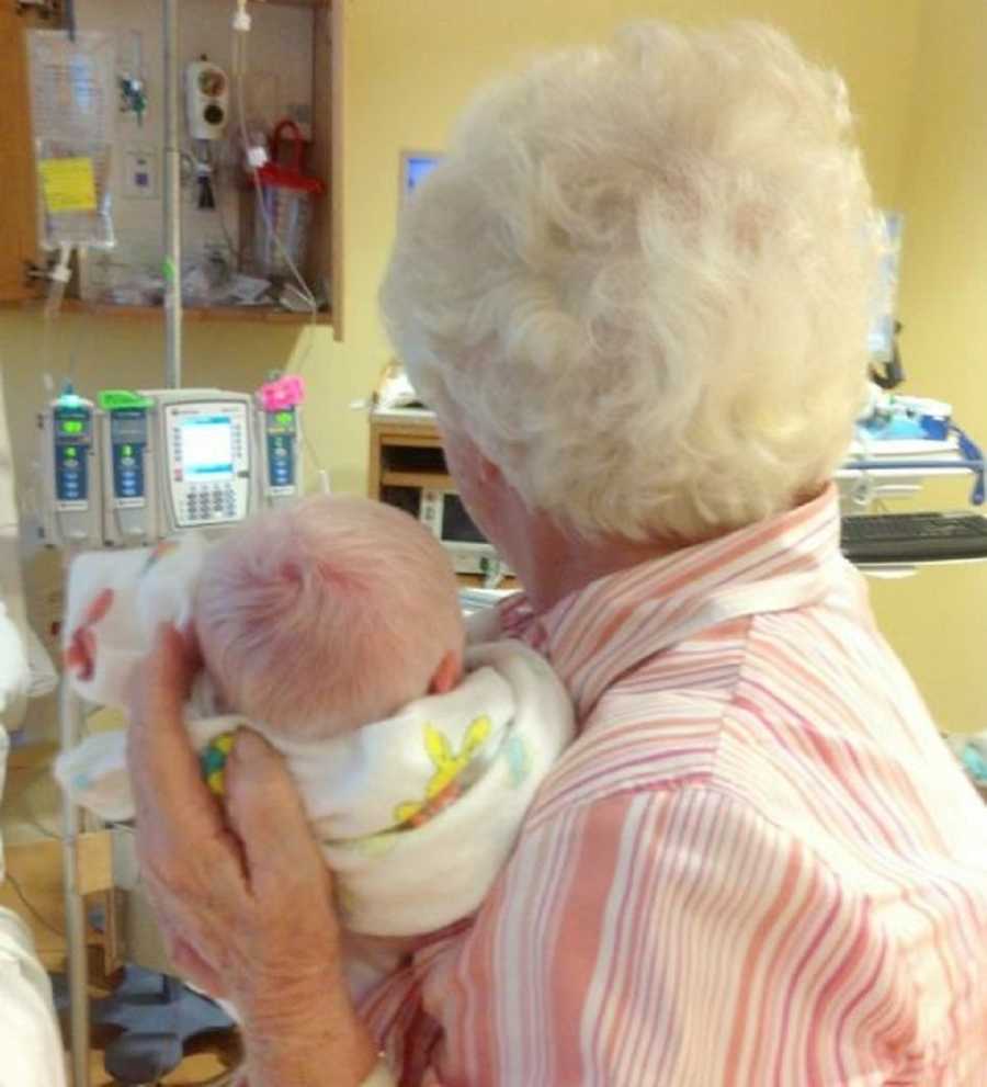 Grandmother with white hair holds newborn albino whose hair is the same color
