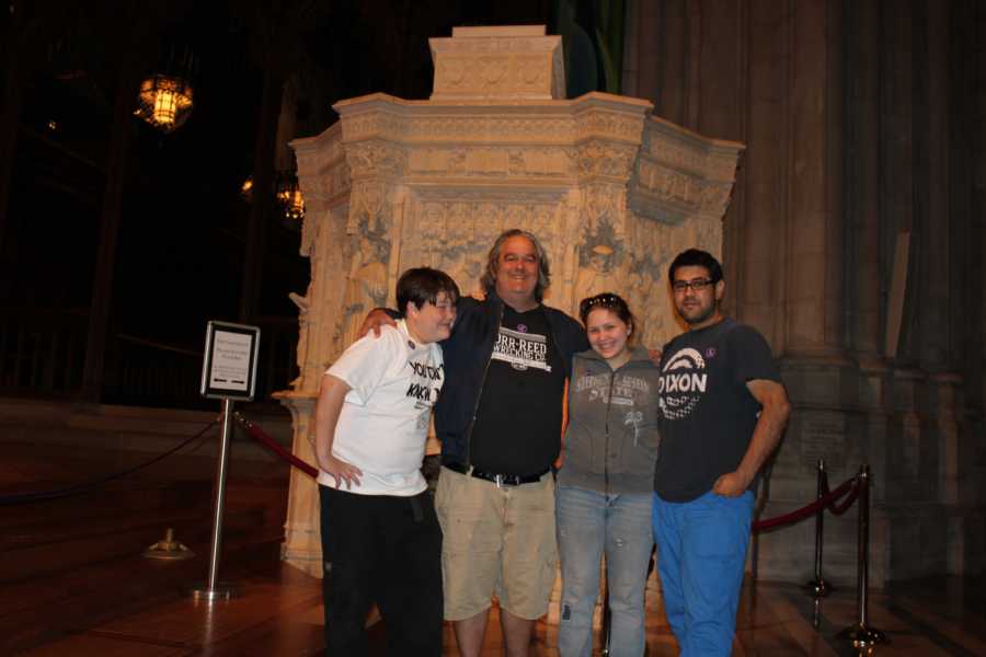 Father who has since passed stands with arms around son and daughter and daughter's fiancee