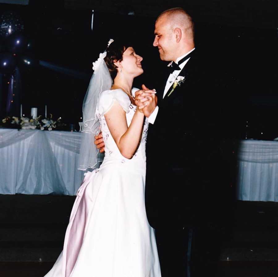 Bride and groom stare into each others eyes as they dance at their wedding ceremony