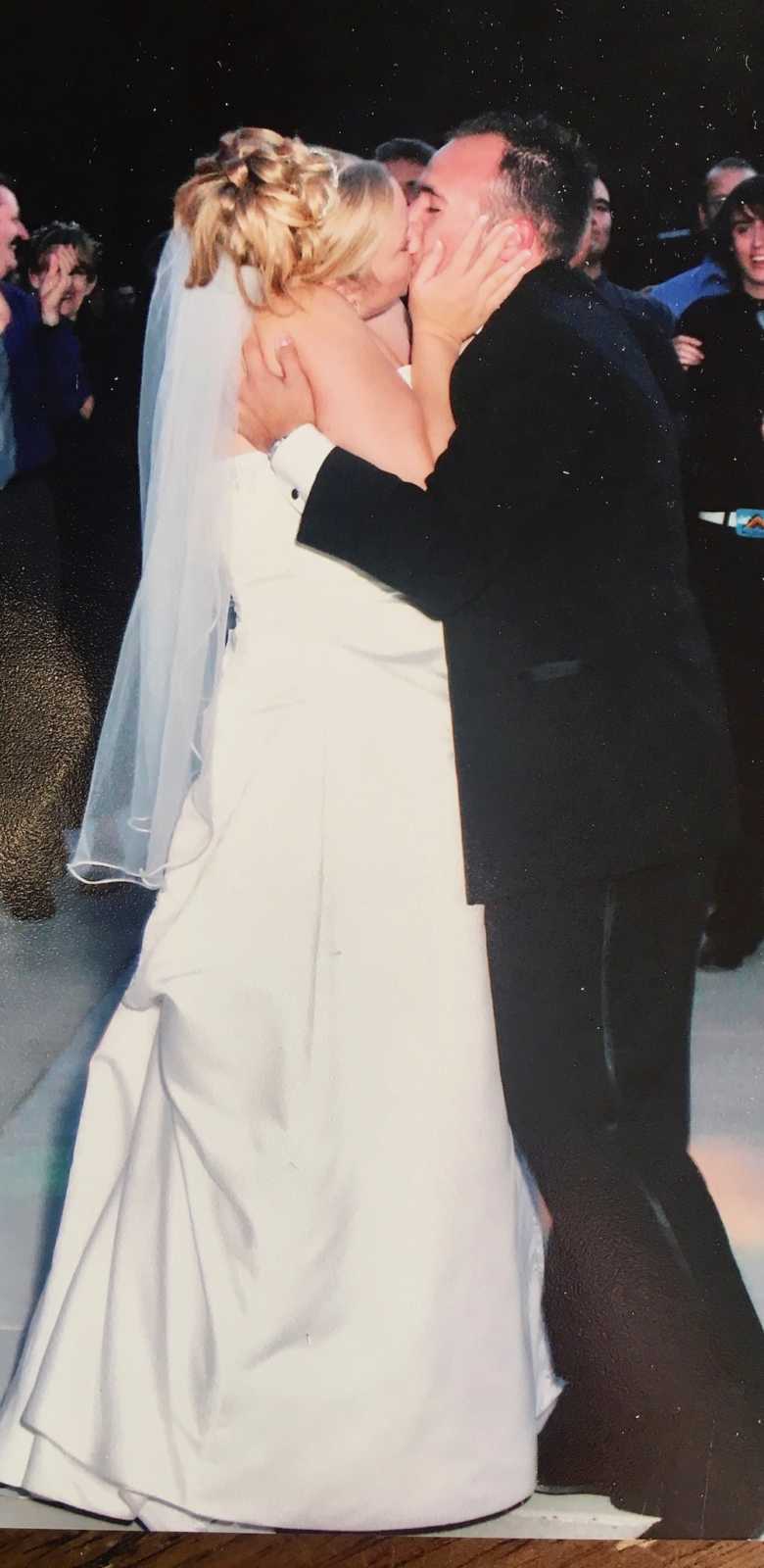 Bride and groom sharing kiss at wedding reception