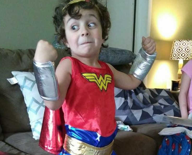 Transgender child flexes his muscles in wonder woman costume