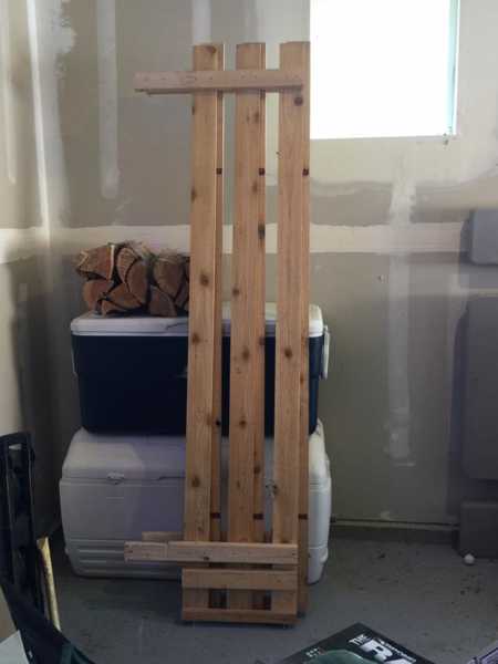 Wooden fence to hold things in bed of truck leaning against coolers in garage