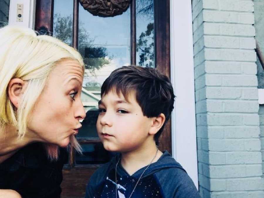 Woman makes kissy face at son who says his dad is perfect in selfie