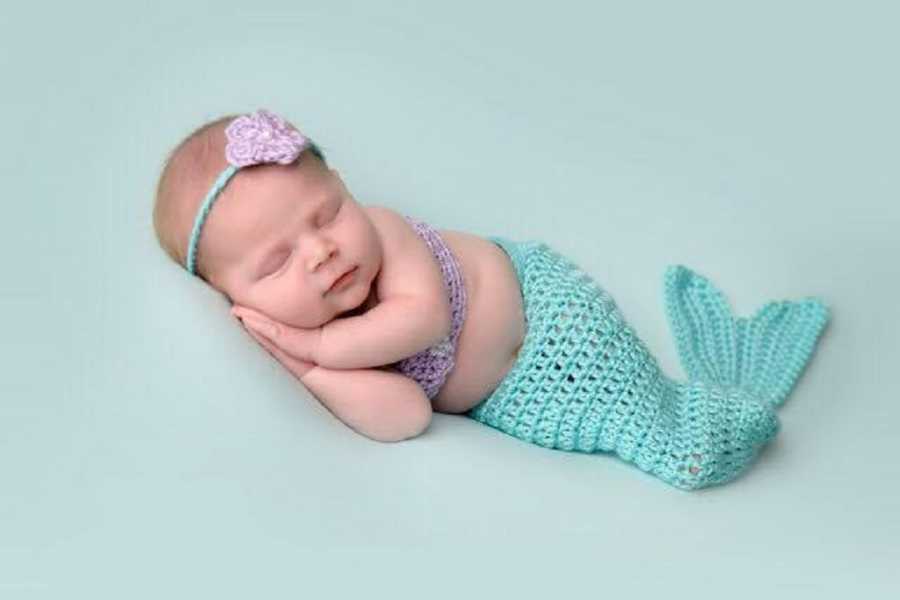 Young baby who was conceived through egg donor lays in mermaid outfit for photoshoot