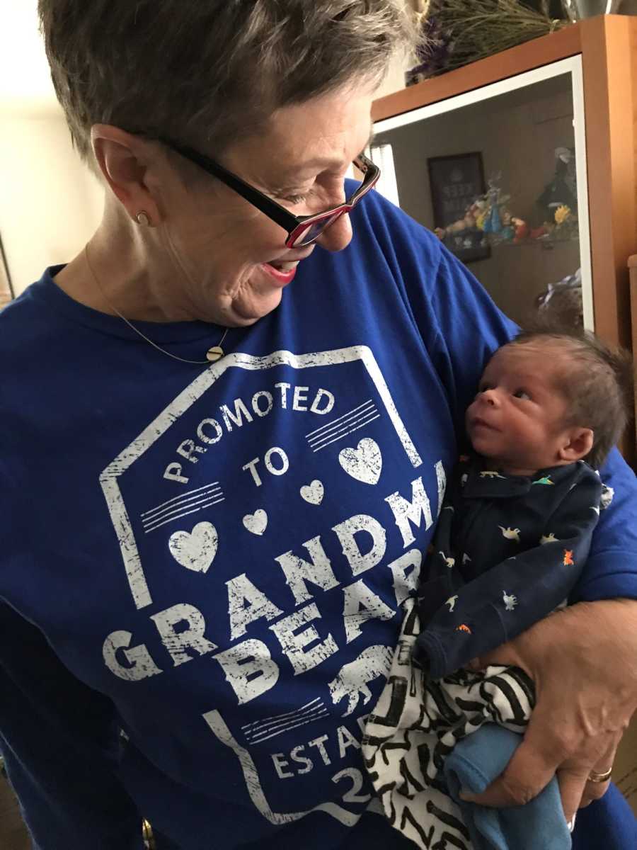 Grandmother holds grandchild with shaken baby syndrome in her arm