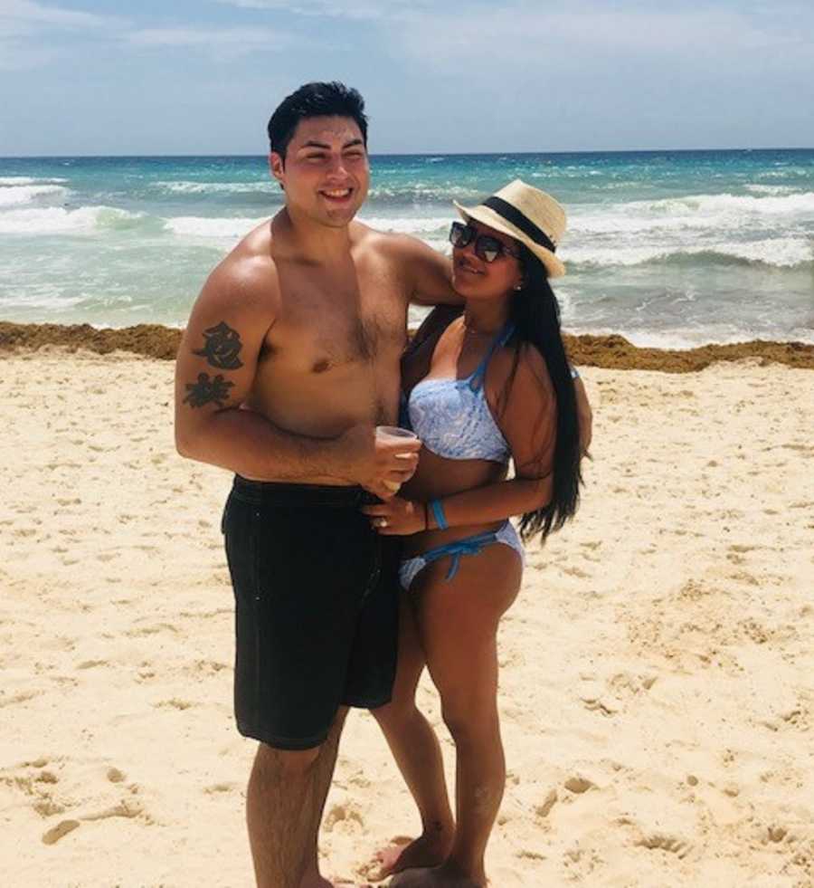 Girlfriend stands smiling on beach with boyfriend who has since passed from heroin addiction