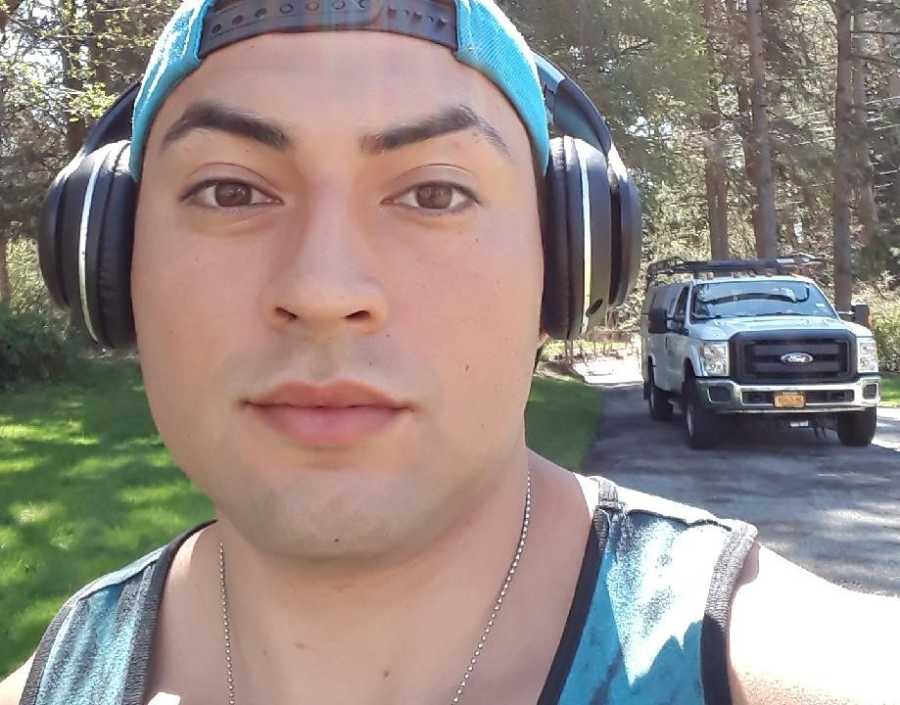 Man who has since passed from heroin addiction takes selfie outside with headphones on