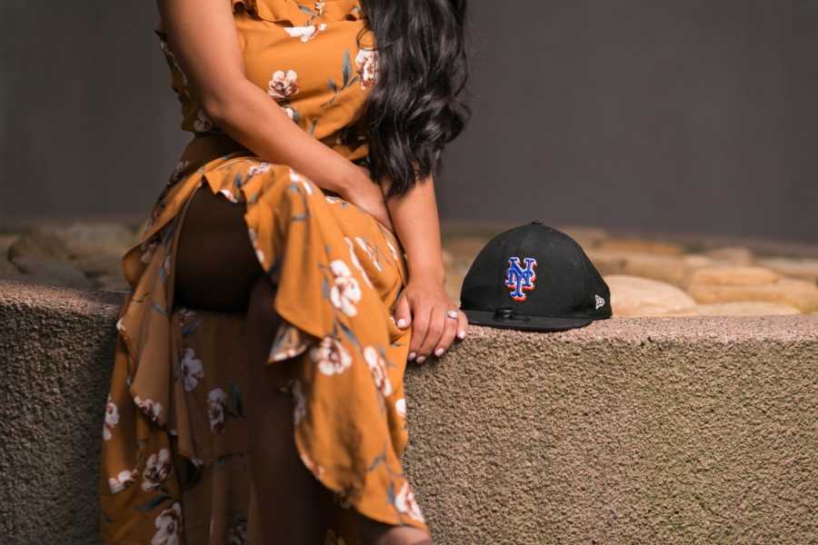 Girlfriend sits on ledge beside New York Mets hat that belonged to her boyfriend that passed from heroin addiction