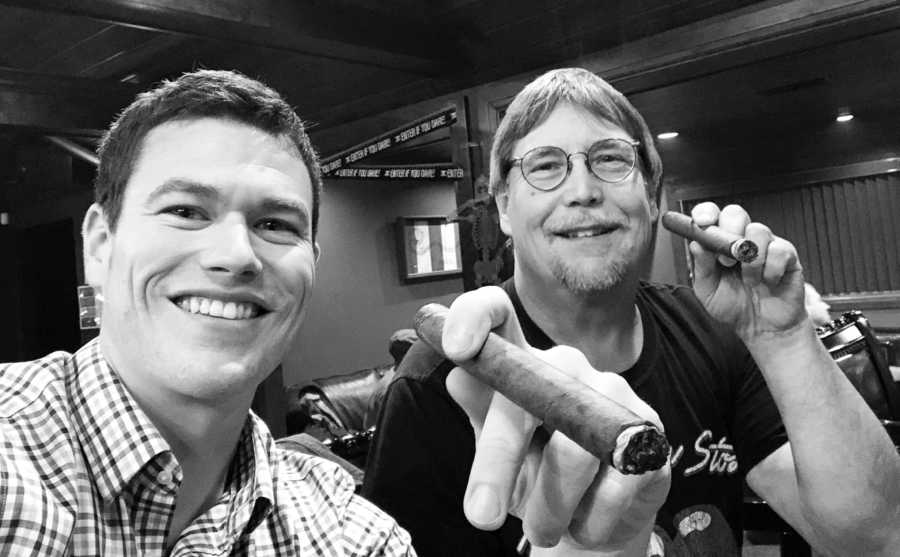 Man smiles in selfie with father who has since passed as they smoke cigars