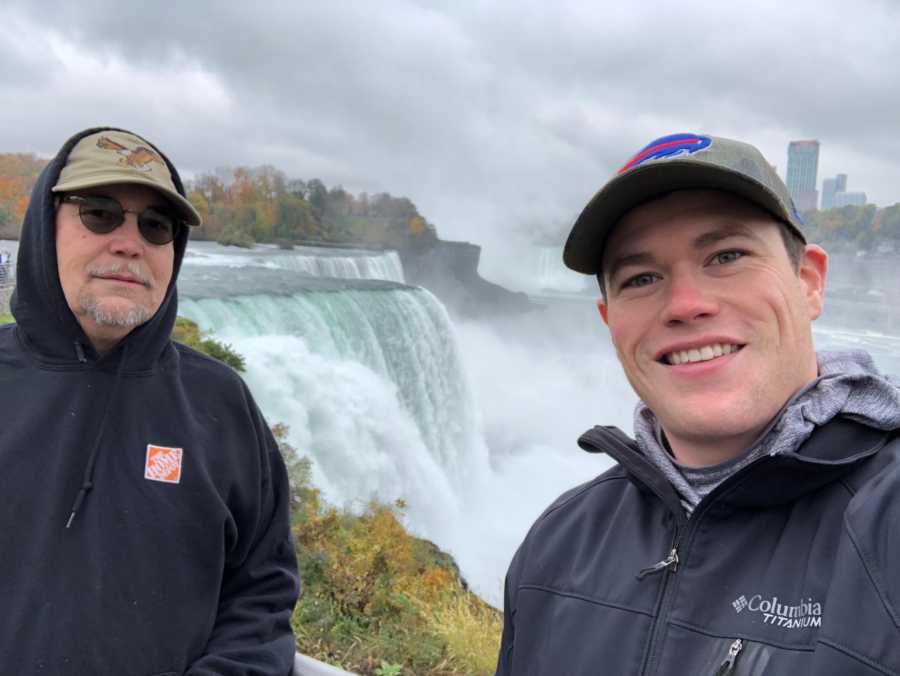 Man stands smiling in selfie with father with cancer by Niagara Falls
