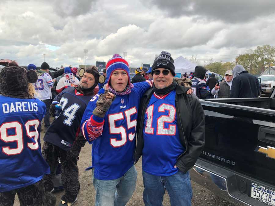 Man stands beside Chevy truck with his father with cancer at Buffalo Bills tailgate