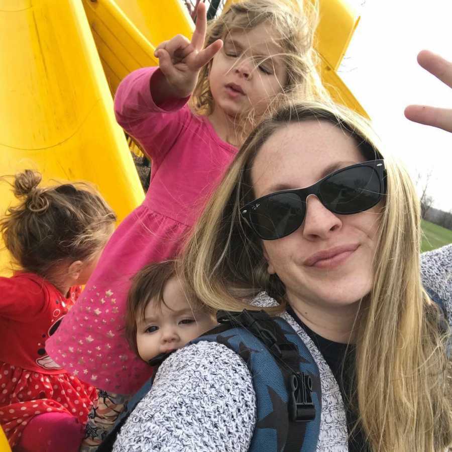 Woman who was asked if she was gonna get her tubes tied smiles in selfie with her three daughters on yellow slide