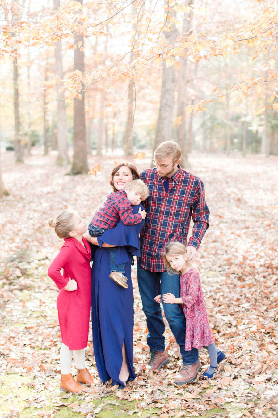 Father with Acute Disseminated Encephalomyelitis stands beside wife who is holding their youngest and two daughters