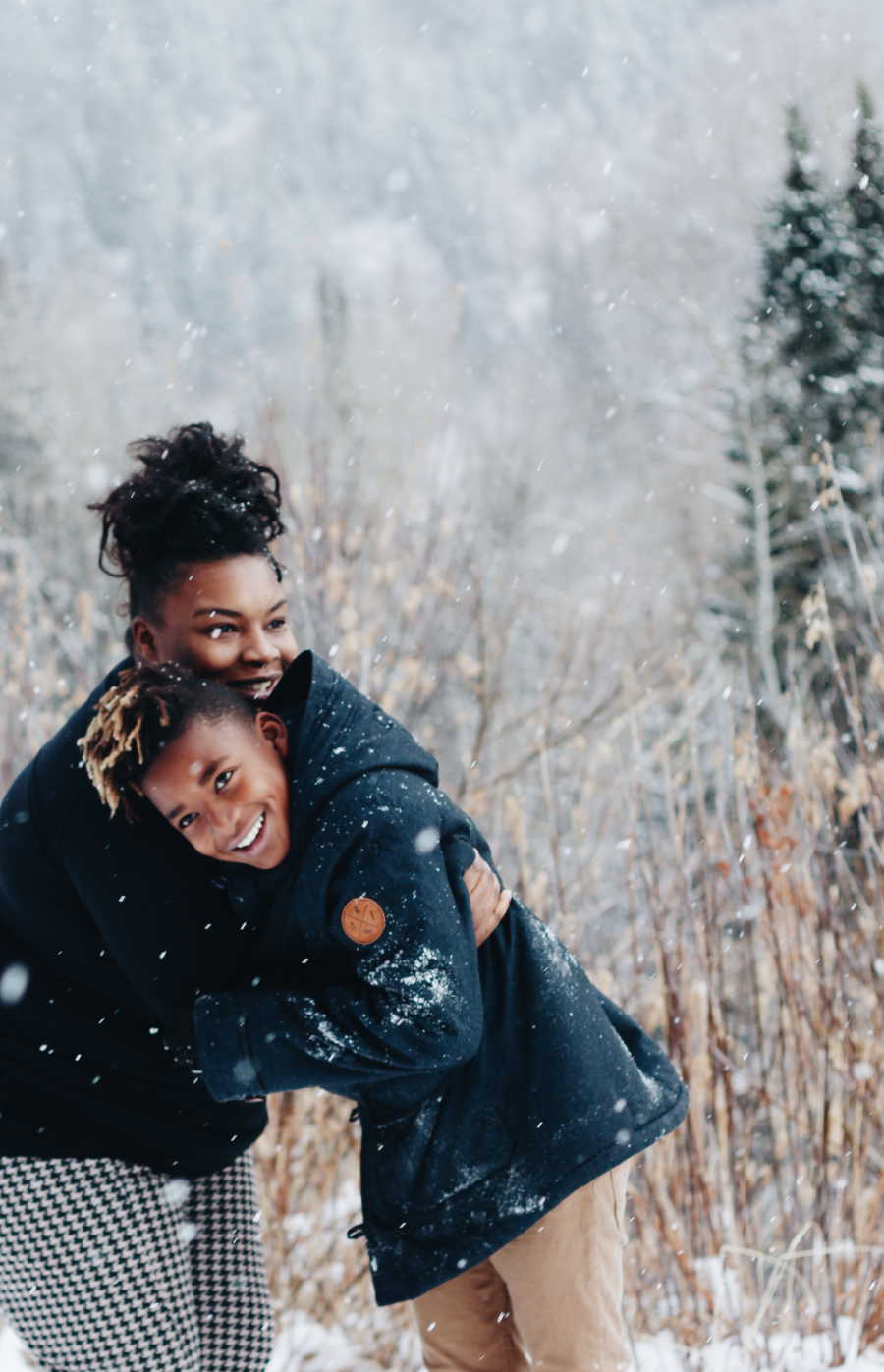 Birth mother stands outside in snowy weather hugging teen she gave up for adoption at birth