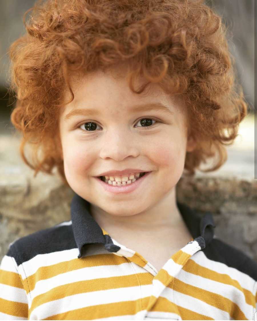 Close up of light skinned African American boy with red curly hair
